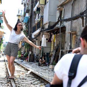 In central Hanoi, foreign tourists turn train track into outdoor studio