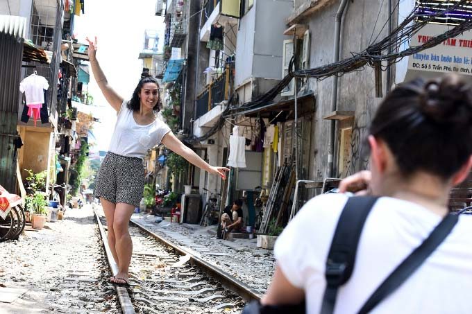 In central Hanoi, foreign tourists turn train track into outdoor studio