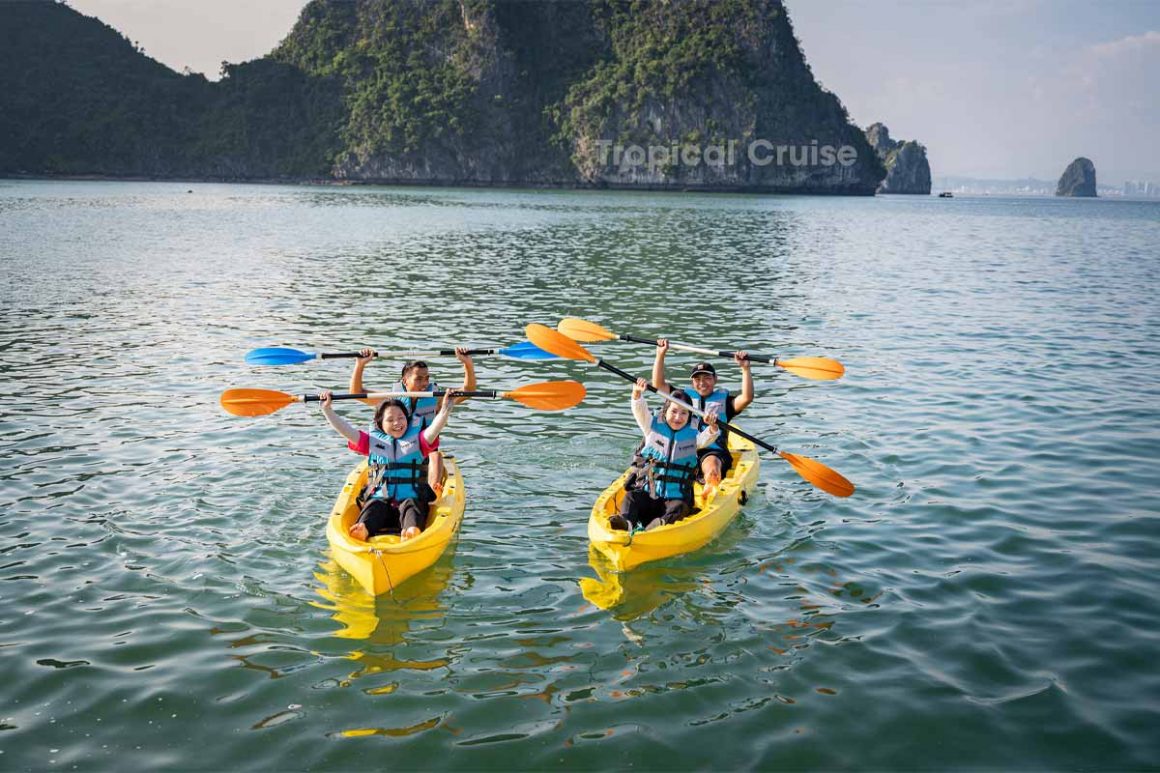 Travelers kayaking between limestone cliffs on Lan Ha Bay 1 day tour
